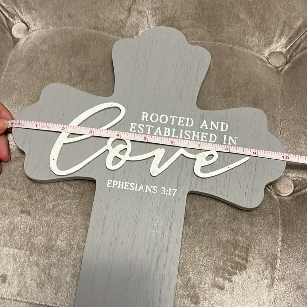 Gray wooden cross with white printing, rooted and established in love, Eph 3:17
